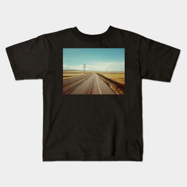 Canadian prairie landscape with a country road near Pincher Creek, Alberta, Canada. Kids T-Shirt by Nalidsa